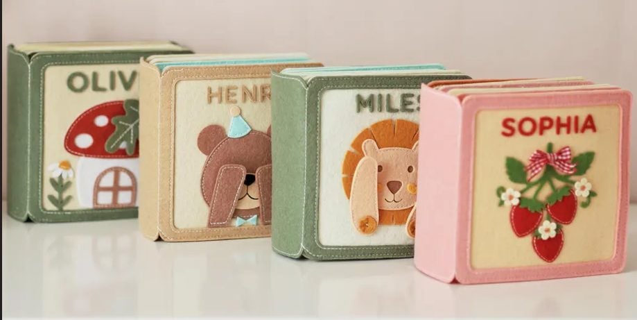 Four personalized quiet books displayed together